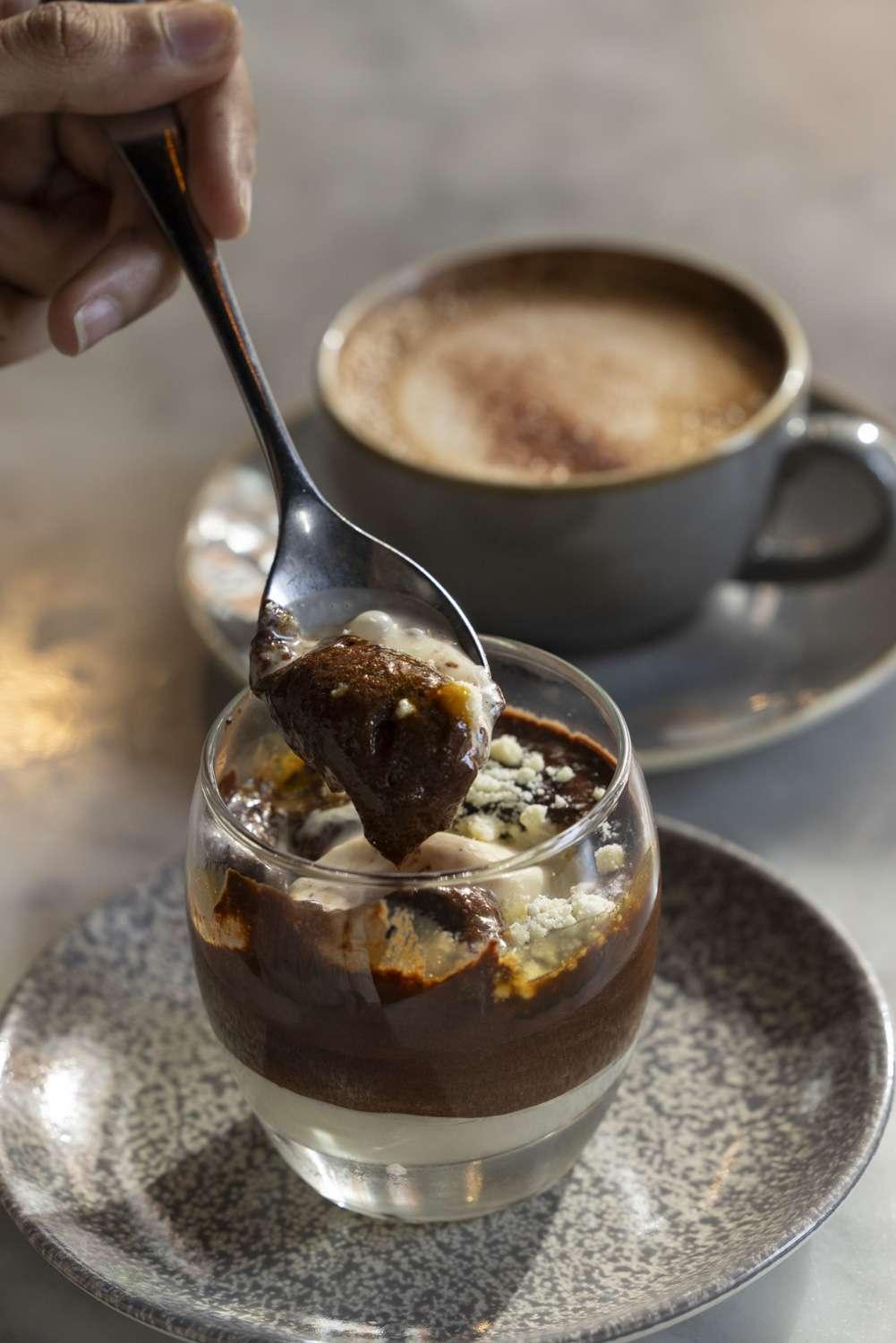 Warm hot chocolate with cream and latte art in ceramic cup close-up